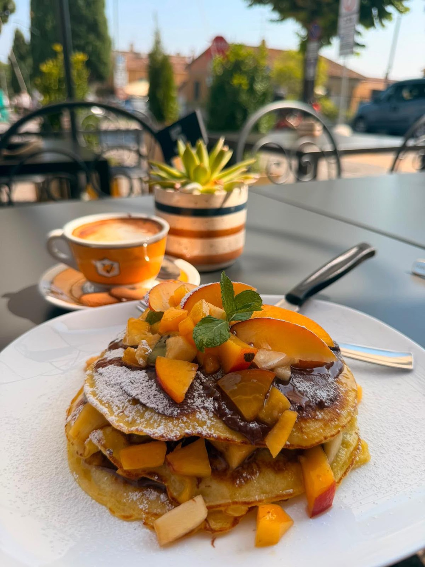 Pancakes served at an outdoor table, brunch café in Pienza